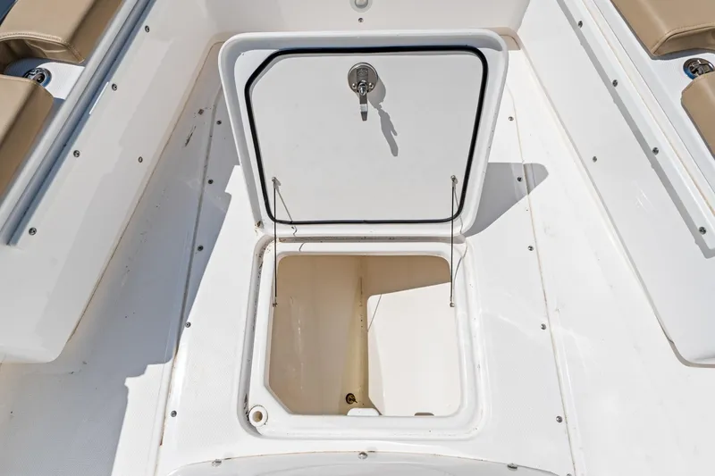 Slide: The Image of 2023 Everglades 243 Center Console boat storage compartment with open hatch. - 22