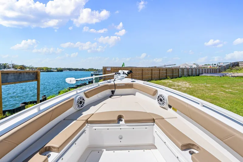 Slide: The Image of 2023 Everglades 243 Center Console boat docked by a scenic waterfront. - 23