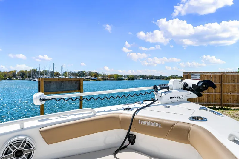 Slide: The Image of 2023 Everglades 243 Center Console boat with Minn Kota motor by a scenic waterfront. - 25