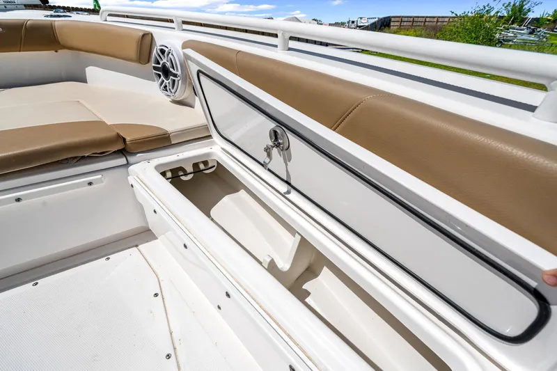 Slide: The Image of 2023 Everglades 243 Center Console boat with open storage compartment and cushioned seating. - 27