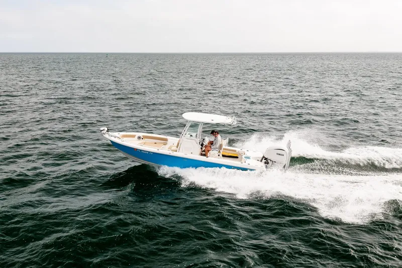 Slide: The Image of 2023 Everglades 243 Center Console boat cruising on open water. - 29