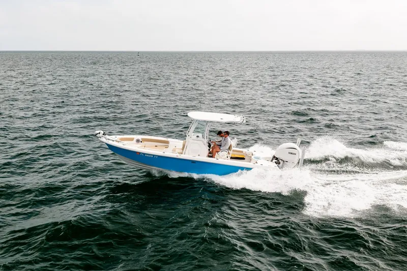 Slide: The Image of 2023 Everglades 243 Center Console boat cruising on open water. - 30