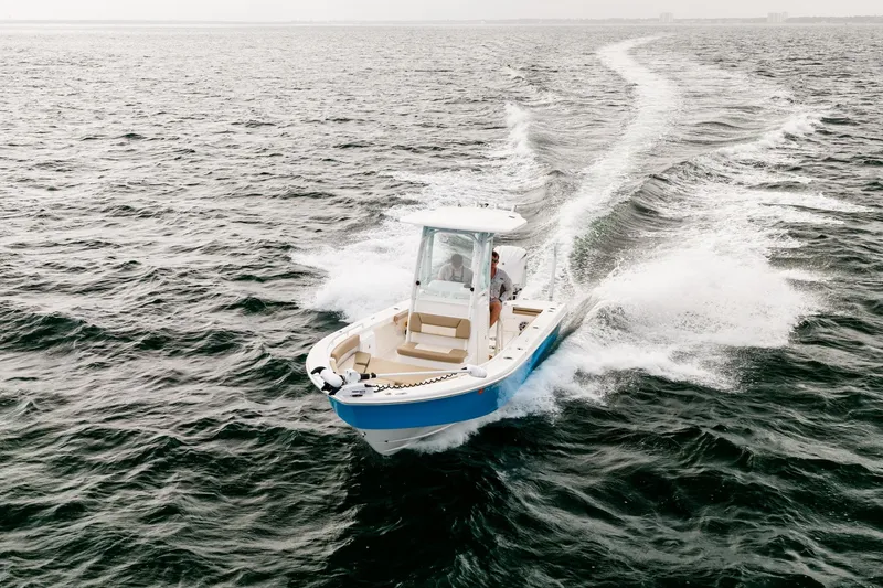 Slide: The Image of 2023 Everglades 243 Center Console boat cruising on open water. - 31