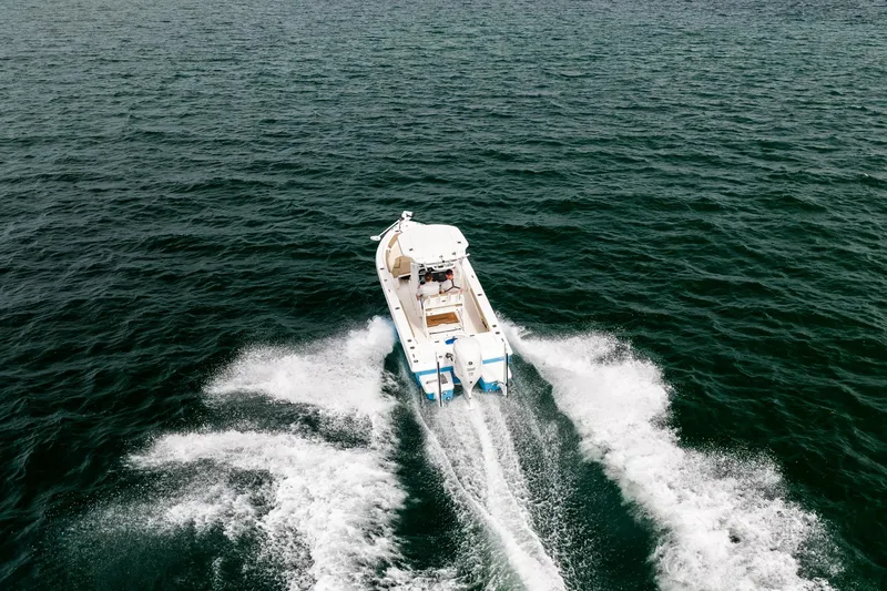 Slide: The Image of 2023 Everglades 243 Center Console boat cruising on open water. - 33