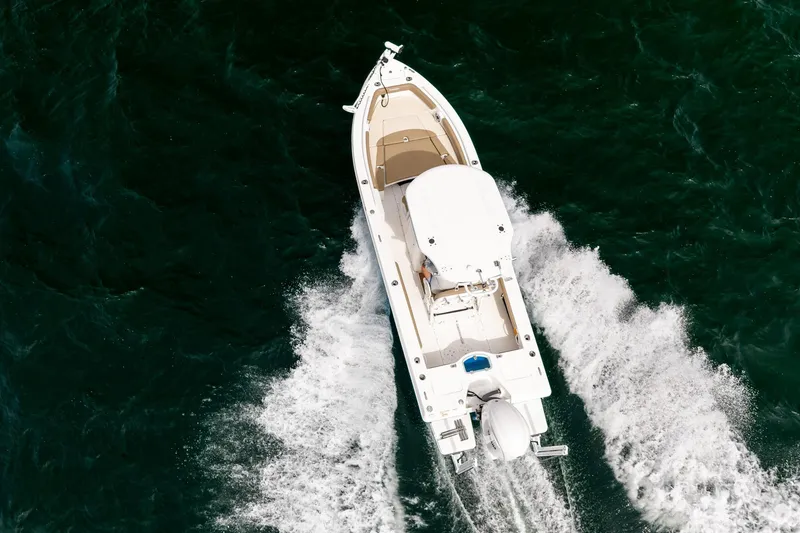Slide: The Image of Overhead view of 2023 Everglades 243 Center Console boat cruising on water. - 34