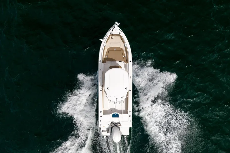 Slide: The Image of Overhead view of 2023 Everglades 243 Center Console boat cruising on water. - 35