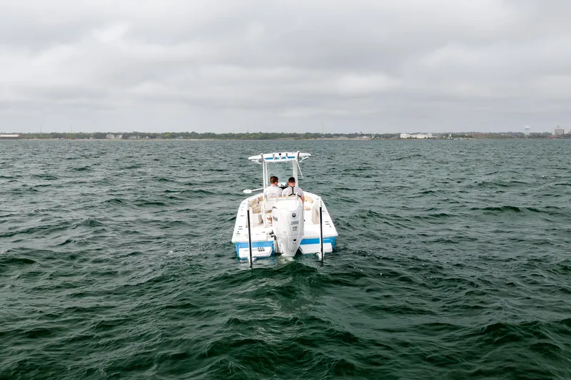 Slide: The Image of 2023 Everglades 243 Center Console boat on open water under cloudy skies. - 37