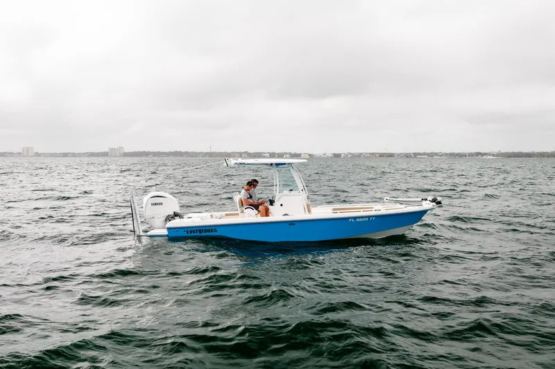 Slide: The Image of 2023 Everglades 243 Center Console boat on open water under cloudy skies. - 38