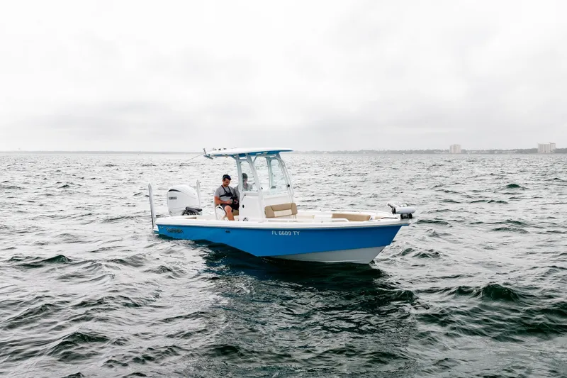 Slide: The Image of 2023 Everglades 243 Center Console boat on open water, overcast sky. - 39