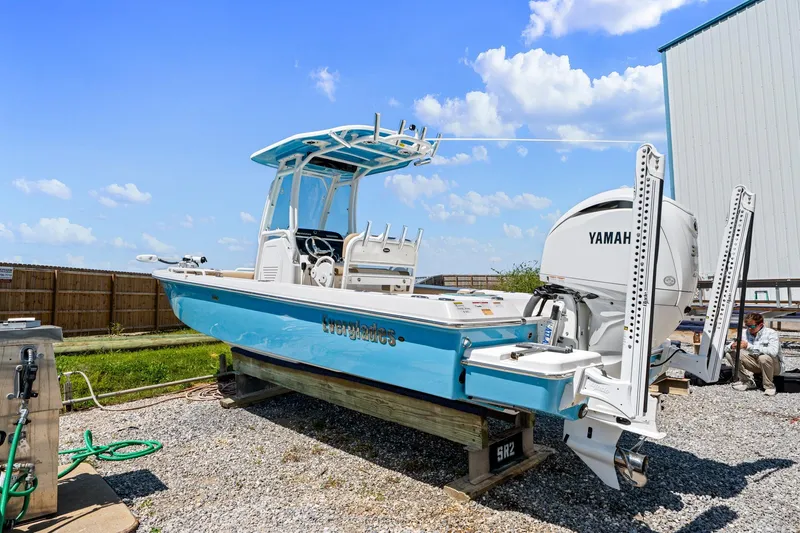 Slide: The Image of 2023 Everglades 243 Center Console boat with Yamaha engine on display outdoors. - 4