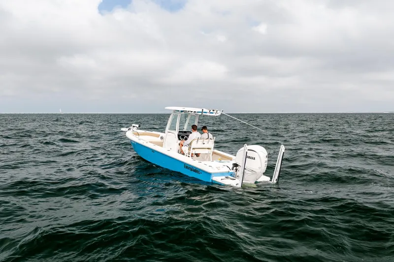 Slide: The Image of 2023 Everglades 243 Center Console boat on open water under cloudy sky. - 41