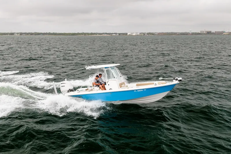 Slide: The Image of 2023 Everglades 243 Center Console boat cruising on open water. - 43