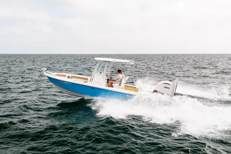 Slide: The Image of 2023 Everglades 243 Center Console boat cruising on open water. - 44