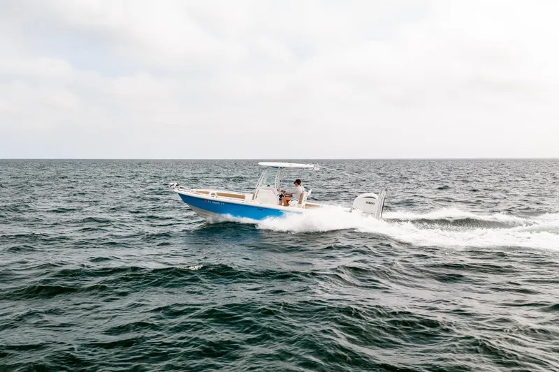 Slide: The Image of 2023 Everglades 243 Center Console boat cruising on open water. - 45