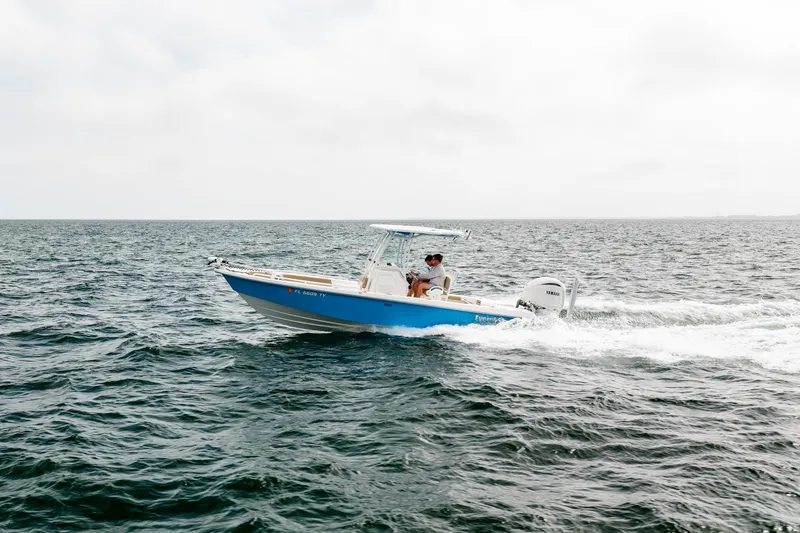 Slide: The Image of 2023 Everglades 243 Center Console boat cruising on open water. - 46