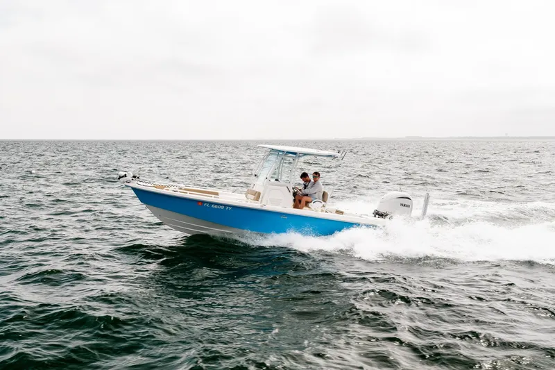 Slide: The Image of 2023 Everglades 243 Center Console boat cruising on open water. - 47