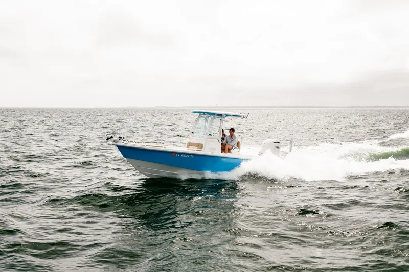 Slide: The Image of 2023 Everglades 243 Center Console boat cruising on open water. - 48