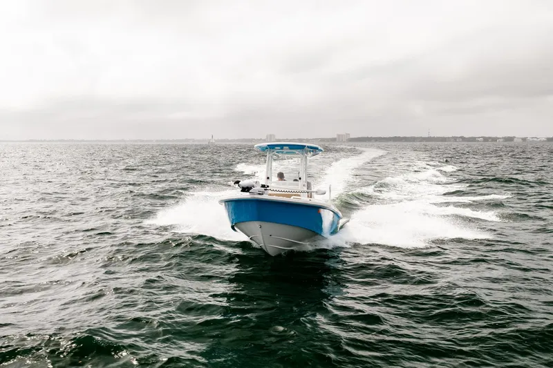 Slide: The Image of 2023 Everglades 243 Center Console boat cruising on open water. - 49