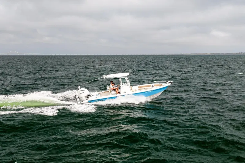 Slide: The Image of 2023 Everglades 243 Center Console boat cruising on open water. - 52