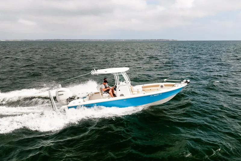 Slide: The Image of 2023 Everglades 243 Center Console boat cruising on open water. - 54