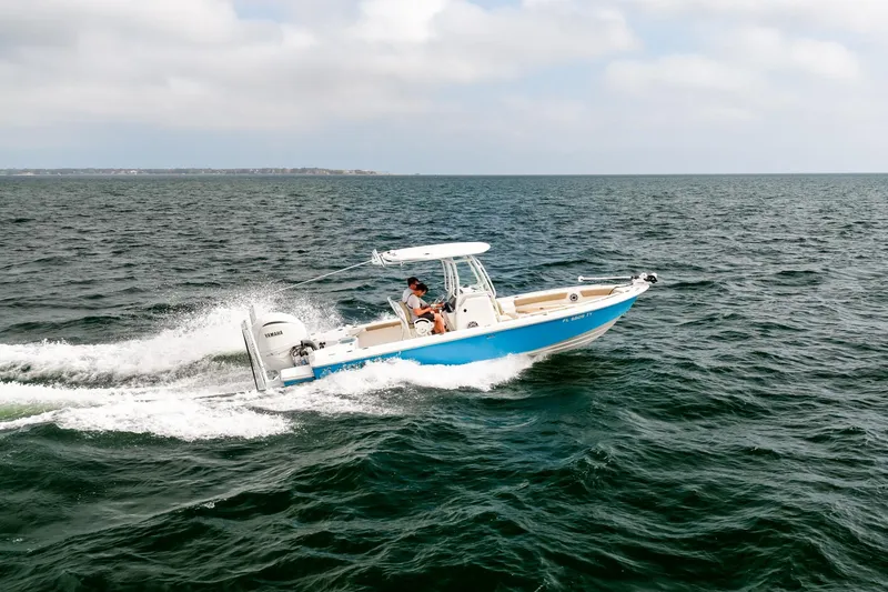 Slide: The Image of 2023 Everglades 243 Center Console boat cruising on open water. - 55