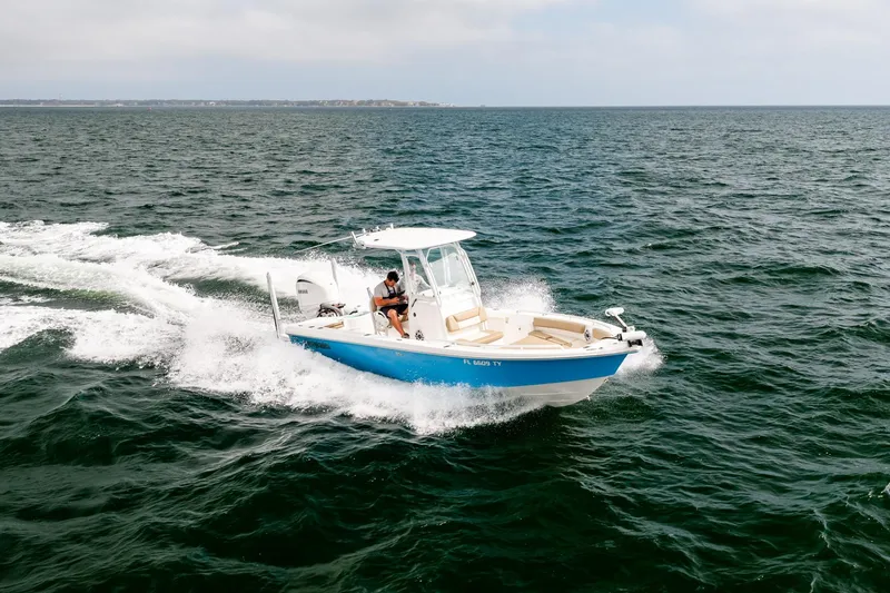 Slide: The Image of 2023 Everglades 243 Center Console boat cruising on open water. - 56