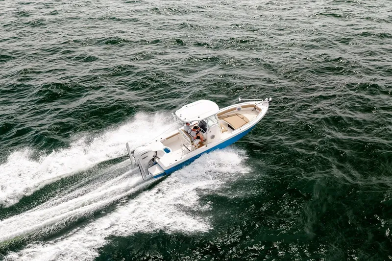 Slide: The Image of 2023 Everglades 243 Center Console boat cruising on open water. - 57