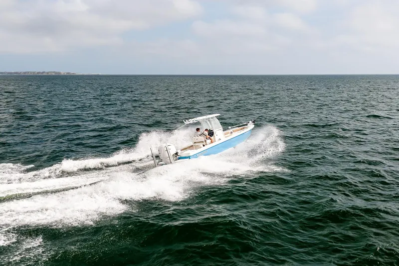 Slide: The Image of 2023 Everglades 243 Center Console boat cruising on open water. - 67