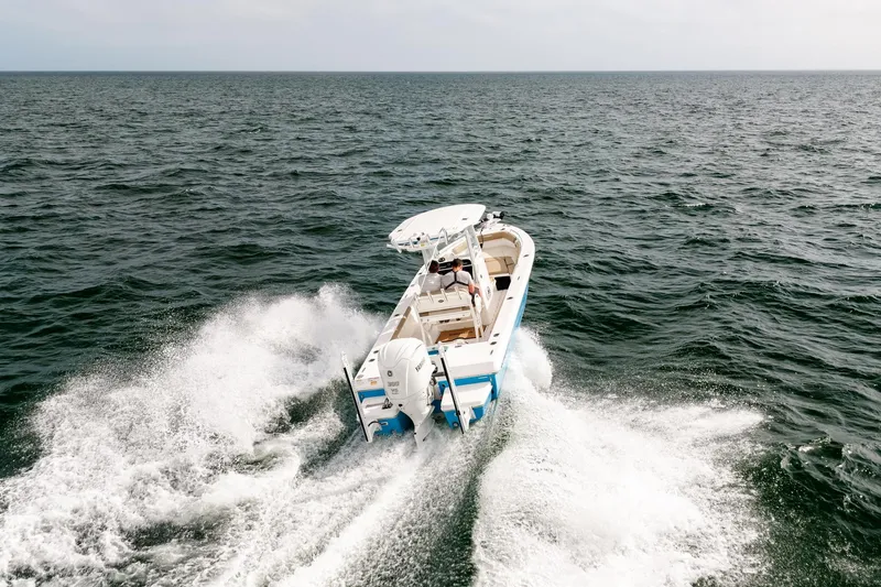 Slide: The Image of 2023 Everglades 243 Center Console boat cruising on open water. - 68