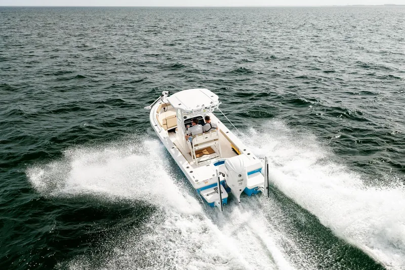 Slide: The Image of 2023 Everglades 243 Center Console boat cruising on open water. - 69