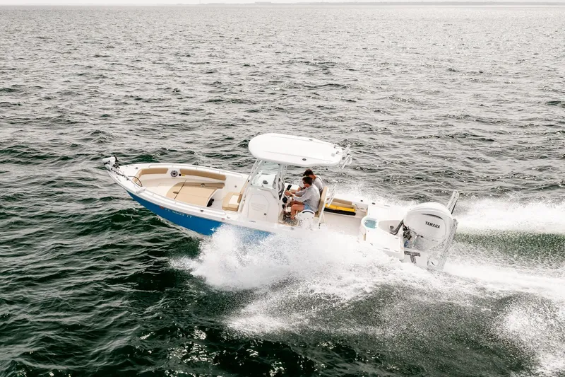 Slide: The Image of 2023 Everglades 243 Center Console boat cruising on open water. - 72