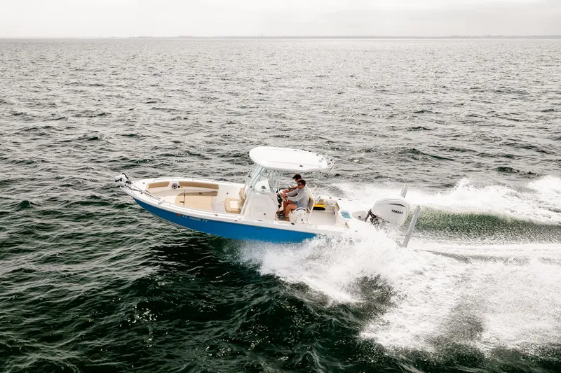 Slide: The Image of 2023 Everglades 243 Center Console boat cruising on open water. - 73