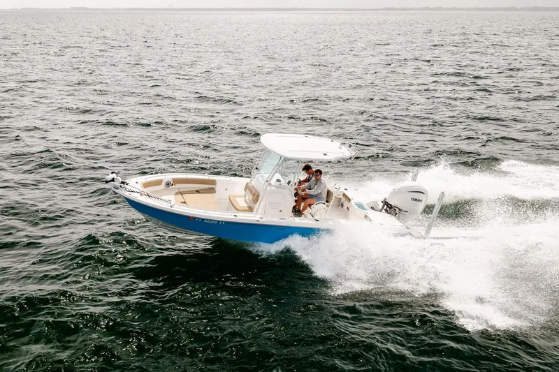 Slide: The Image of 2023 Everglades 243 Center Console boat cruising on open water. - 74