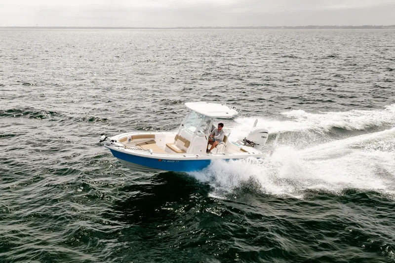 Slide: The Image of 2023 Everglades 243 Center Console boat cruising on open water. - 75