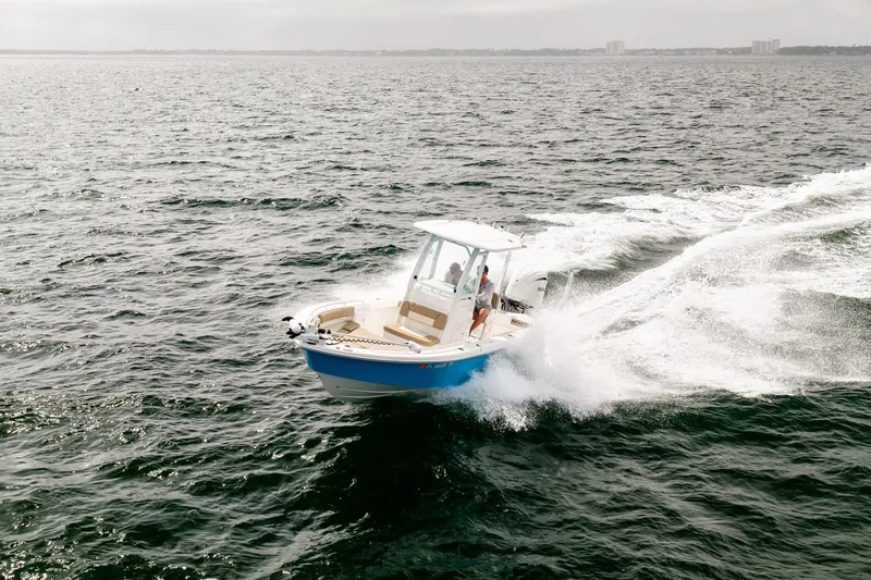 Slide: The Image of 2023 Everglades 243 Center Console boat cruising on open water. - 76
