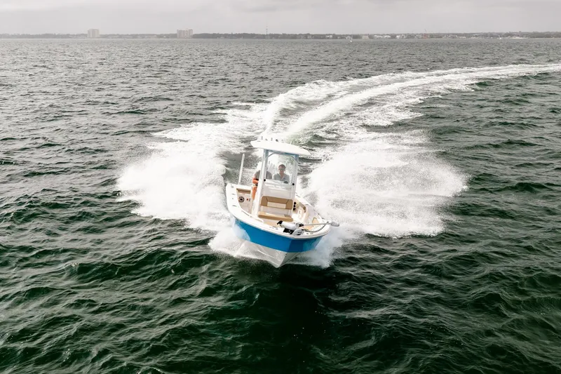 Slide: The Image of 2023 Everglades 243 Center Console boat cruising on open water. - 77