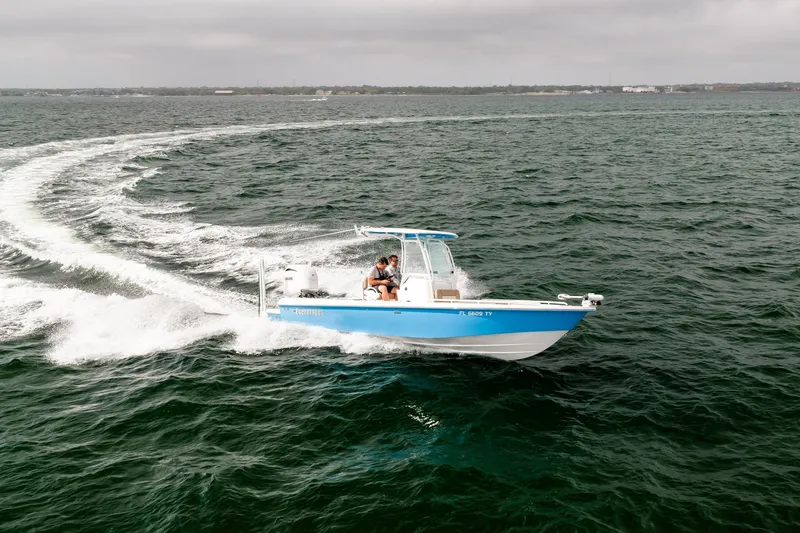 Slide: The Image of 2023 Everglades 243 Center Console boat cruising on open water. - 78