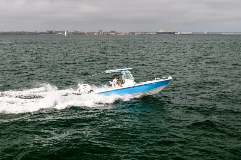 Slide: The Image of 2023 Everglades 243 Center Console boat cruising on open water. - 79