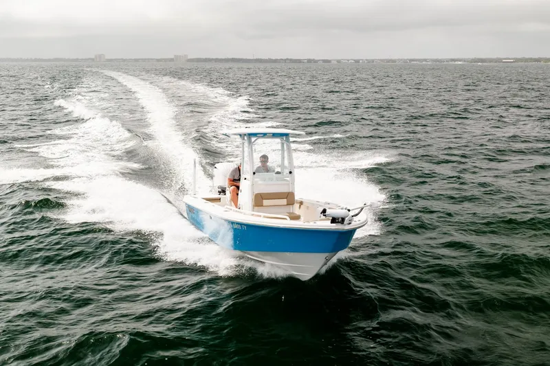 Slide: The Image of 2023 Everglades 243 Center Console boat cruising on open water. - 81