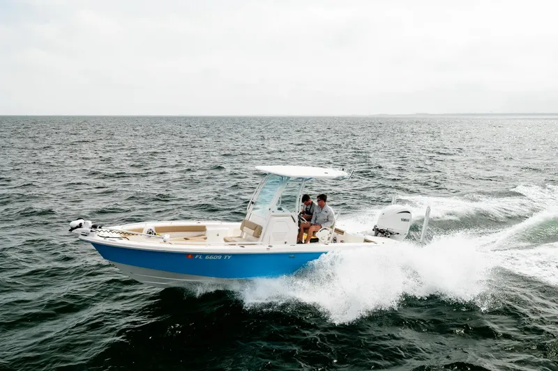 Slide: The Image of 2023 Everglades 243 Center Console boat cruising on open water. - 82