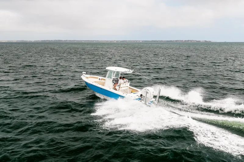 Slide: The Image of 2023 Everglades 243 Center Console boat cruising on open water. - 83