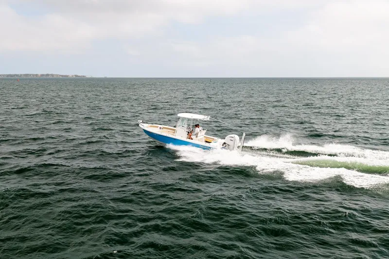 Slide: The Image of 2023 Everglades 243 Center Console boat cruising on open water. - 84