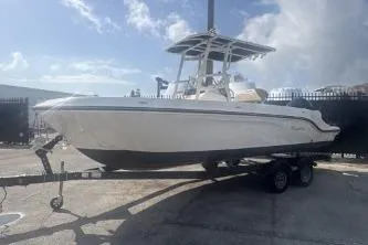The Image of 2023 Bayliner Trophy T22CC boat on trailer under clear sky. - 1