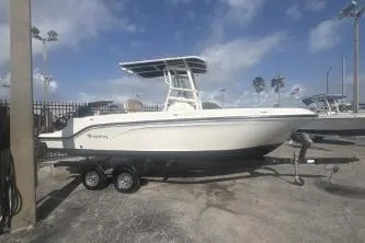 Slide: The Image of 2023 Bayliner Trophy T22CC boat on trailer under blue sky. - 3