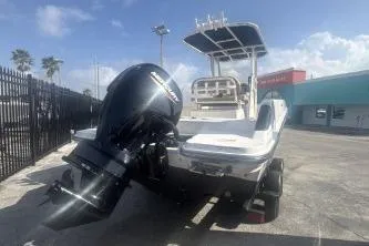 Slide: The Image of 2023 Bayliner Trophy T22CC boat with outboard motor, parked outdoors. - 4