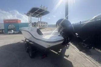 Slide: The Image of 2023 Bayliner Trophy T22CC boat parked outdoors under sunlight. - 5