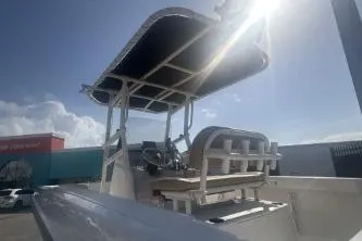 Slide: The Image of 2023 Bayliner Trophy T22CC boat with canopy under bright sunlight. - 6