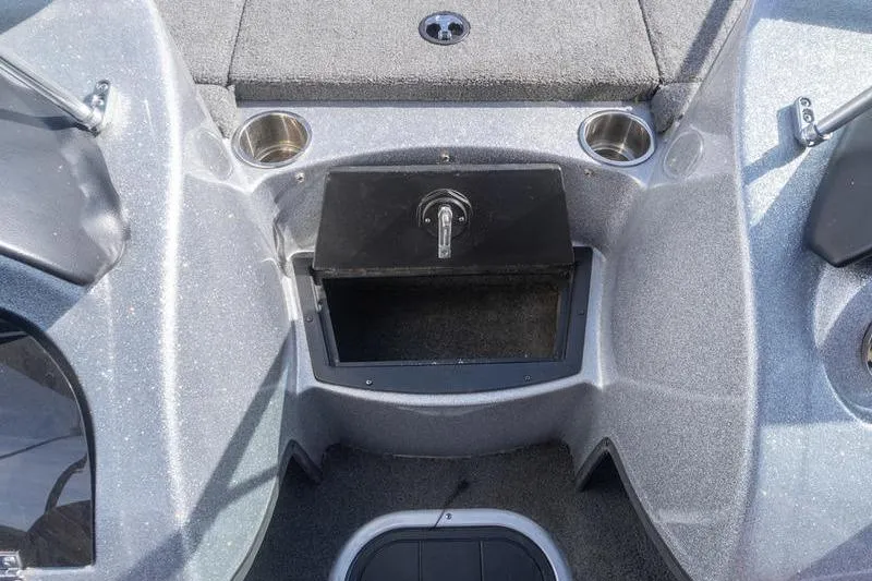 Slide: The Image of 2012 Triton 190 SE boat interior with storage compartment and cup holders. - 11