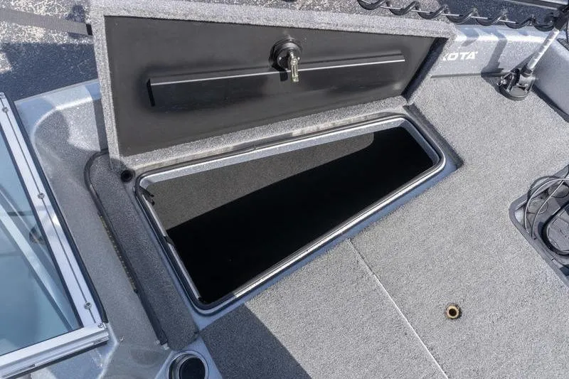 Slide: The Image of Open storage compartment on a 2012 Triton 190 SE boat deck. - 16