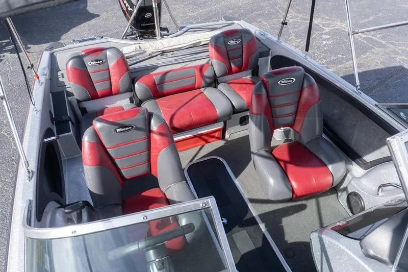 Slide: The Image of Interior of a 2012 Triton 190 SE boat with red and gray seating. - 18